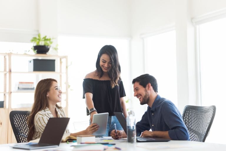 Two women and a man working together