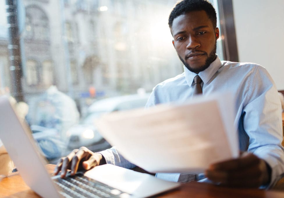 Paperwork Serious employer reading resumes of candidates for vacancy
